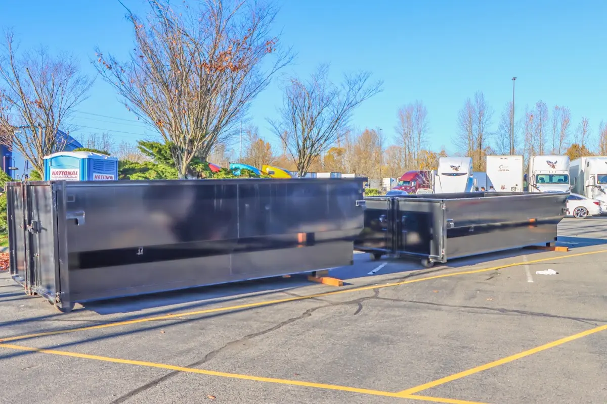 Professional dumpster rental service with roll-off container on residential driveway in DeBary